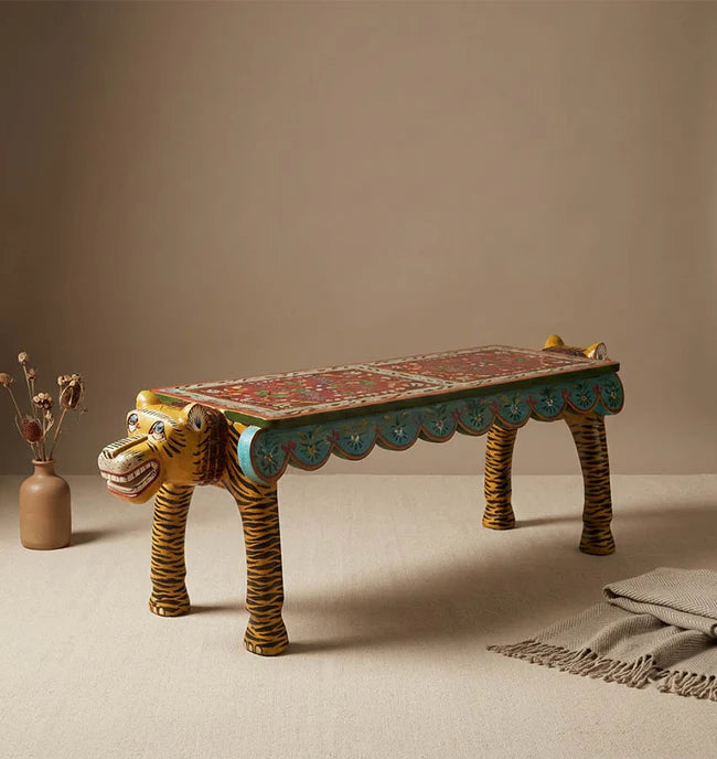 Decorative bench shaped like a lion with intricate designs on a beige background