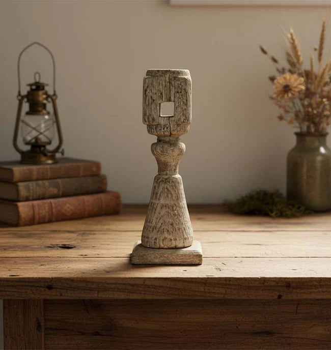 Wooden candle holder on a wooden surface with a rustic background