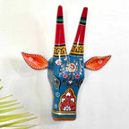 Decorative wall art of a blue deer head with red antlers on a white background