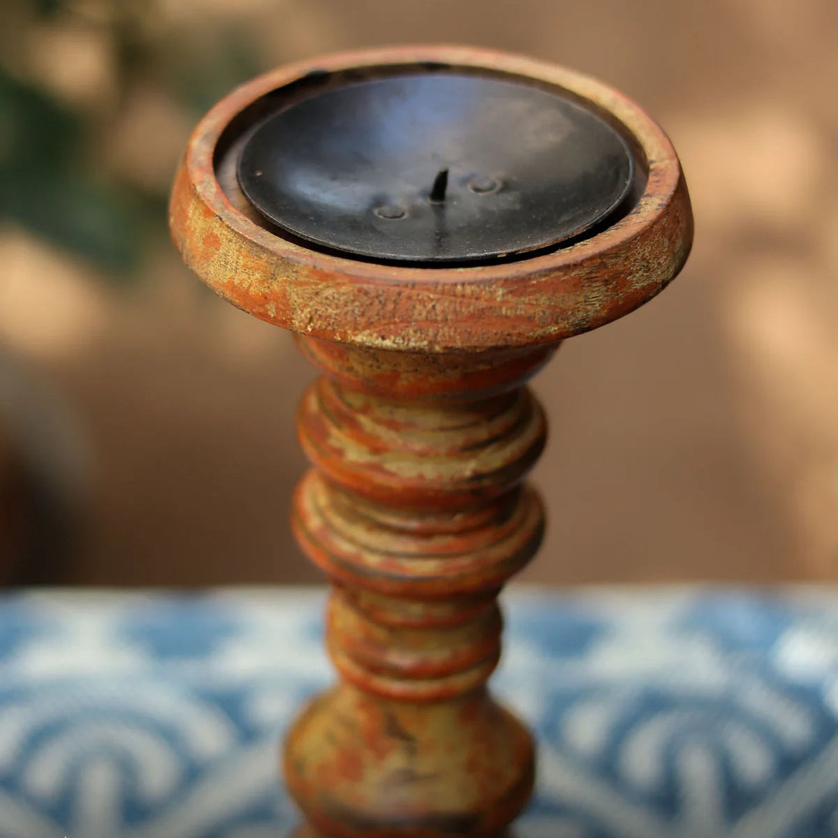 Decorative candle holder with a candle on a blurred background
