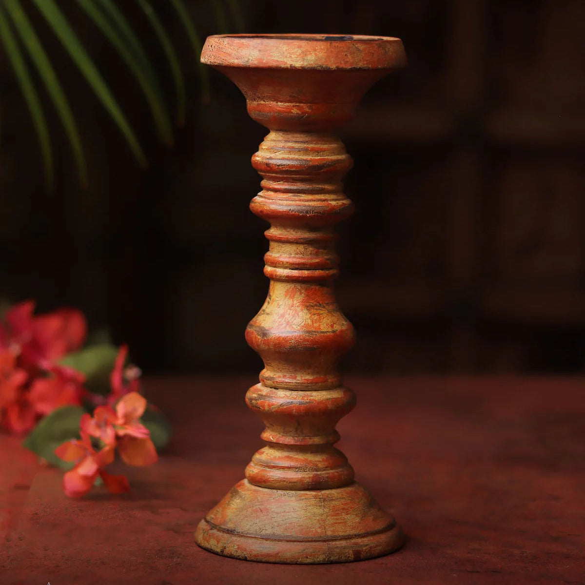 Rust-colored candle holder on a dark background.