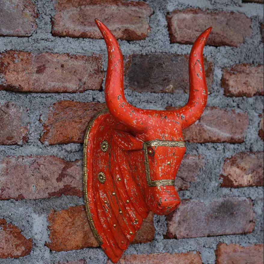 Red bull head wall decoration on a brick wall