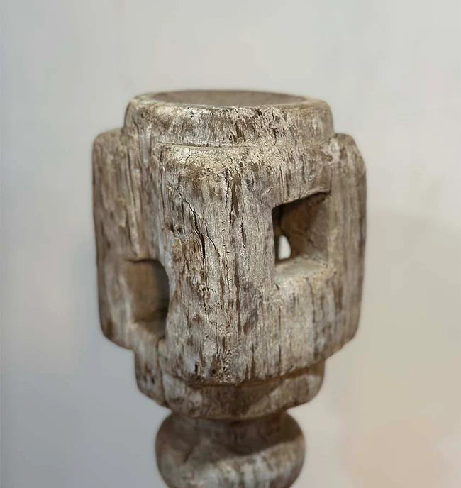 Wooden candle holder with a textured surface on a plain background