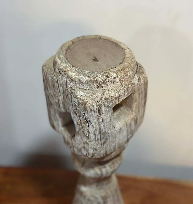 Wooden candle holder with a textured surface on a blurred background