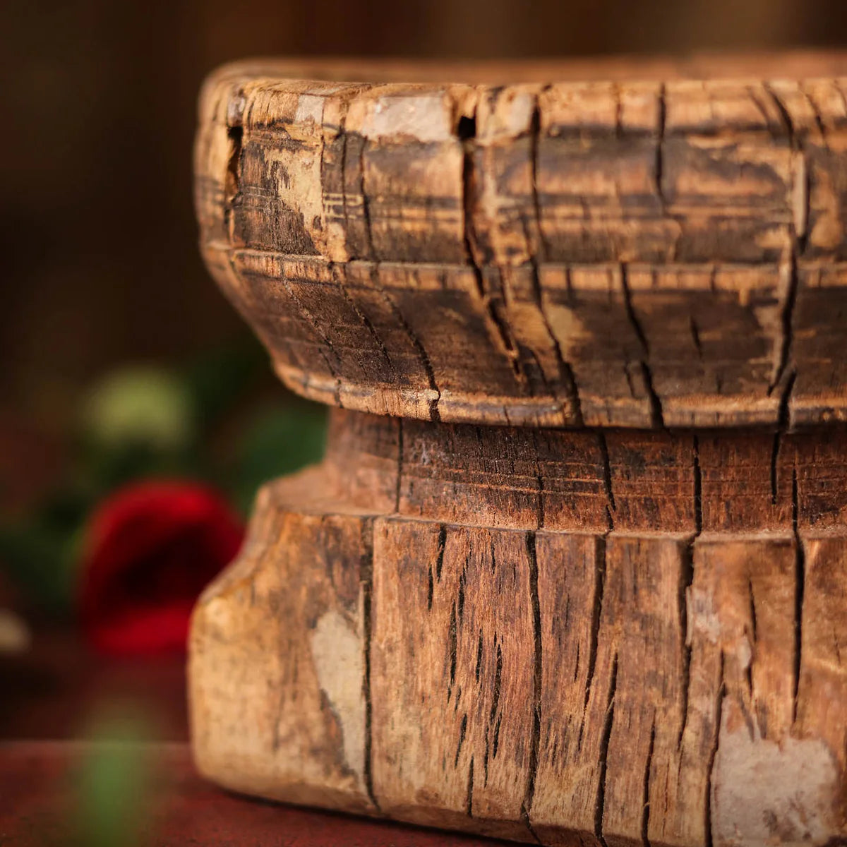 Wooden architectural element with intricate carvings on a blurred background