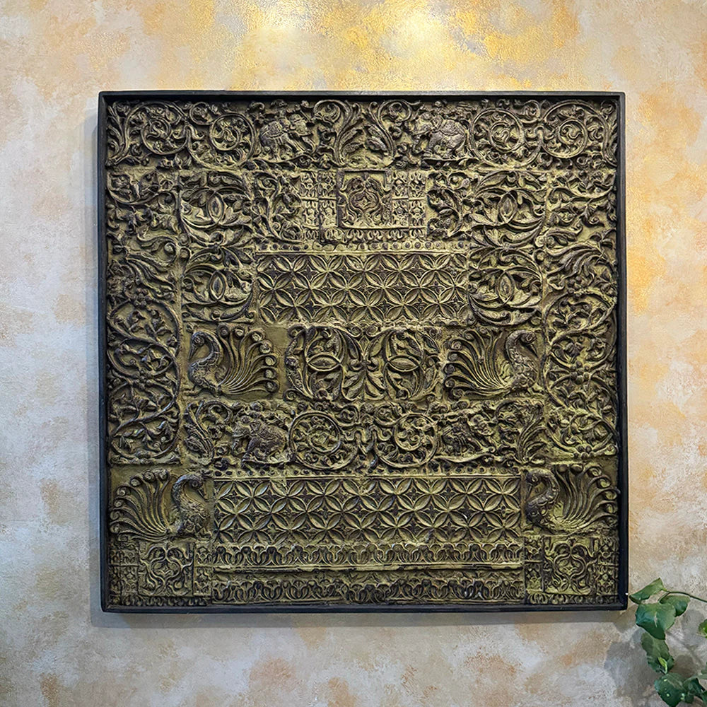 Decorative wall art with intricate patterns on a beige wall.
