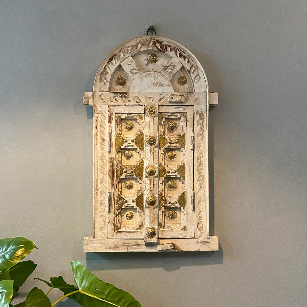 Decorative wall piece with intricate design on a gray wall