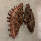 Decorative wall art with horse head and armor design on a textured wall.